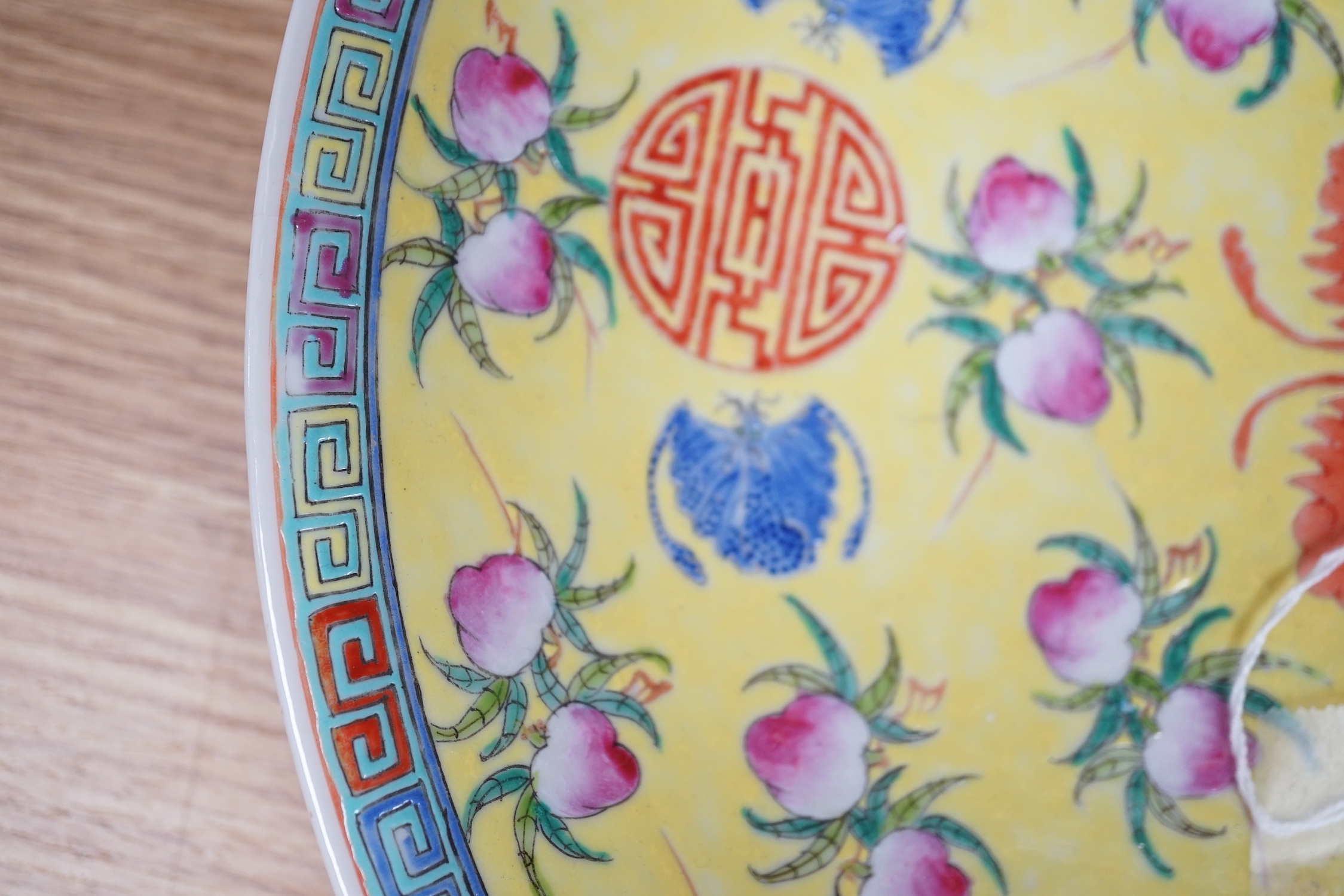 A Chinese yellow ground ‘peaches and bats’ dish, Republic period, 32.7cm diameter, hairline crack to rim